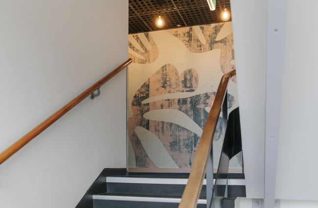 A view of artwork on a wall in a staircase.