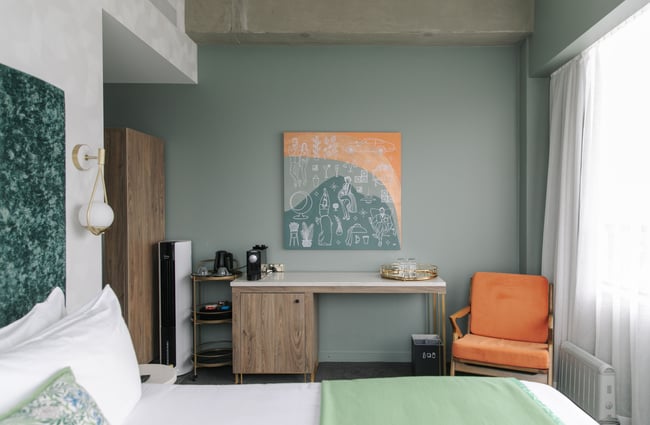 A hotel room deocorated in muted hues.