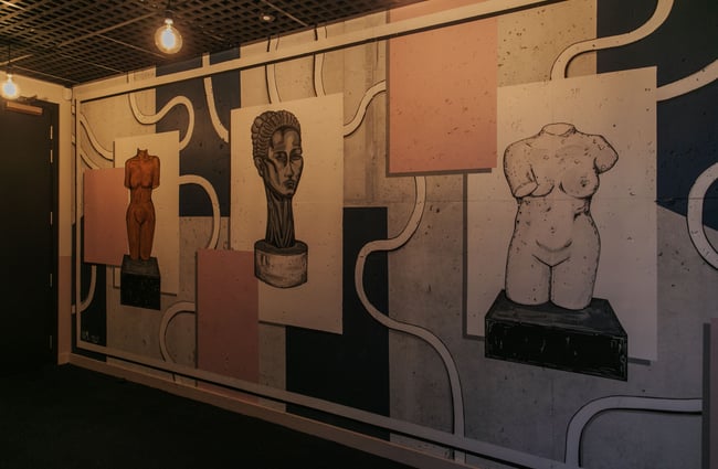 Works of art on a wall inside the Muse Art Hotel.