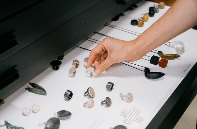 Person reaching for jewellery in drawer at The National gallery in Christchurch