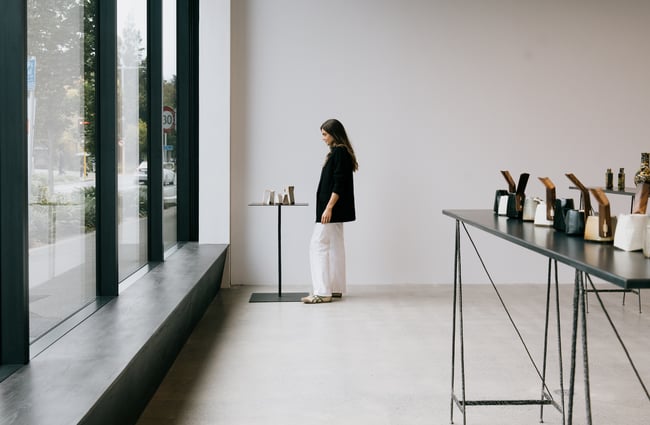 Woman standing next to ceramic on display at The National gallery in Christchurch