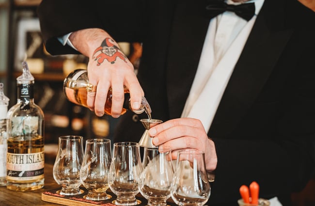 Bartender pouring tasters at The NZ Whisky Cellar Door.