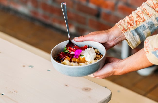 Smoothie bowl being held by a person at The Oatery, Wellington.