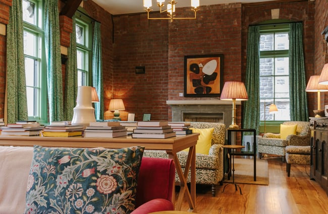 Blue flowery cushion on couch complementing the modern gothic room.