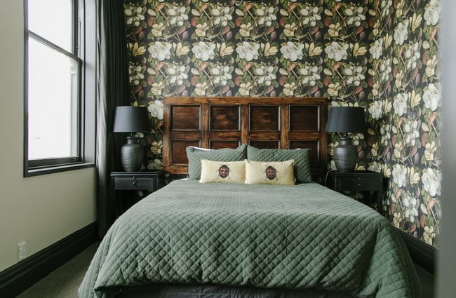 A luxuriously decorated bedroom in green and yellow.