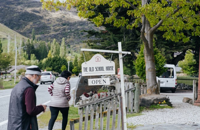 People walking into the front yard of The Old School House.