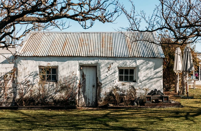 An old house outside on a sunny day.