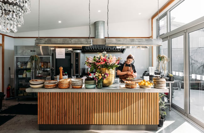 A chef working behind a kitchen counter.