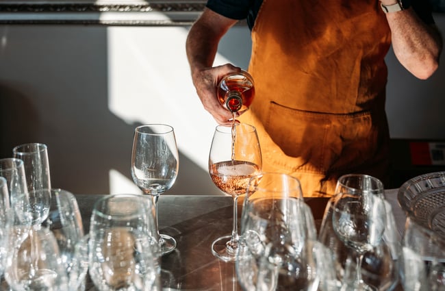 A glass of wine being poured.