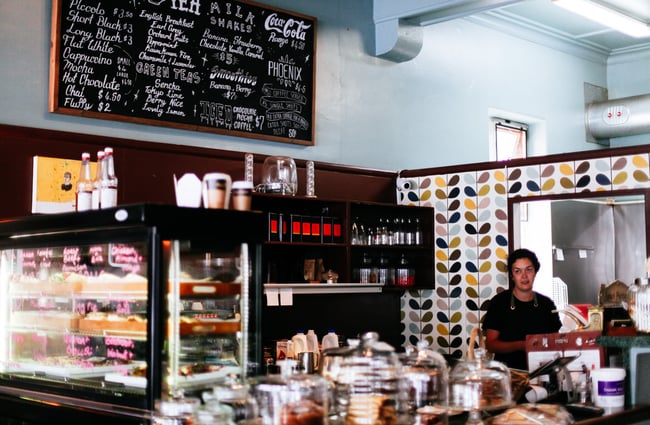 Behind the counter in the cafe.
