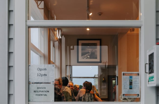 Looking through the window from the outside into the inside of The Pier Hotel.