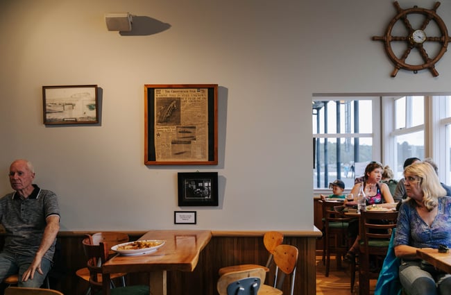 Empty table with artwork hanging above.
