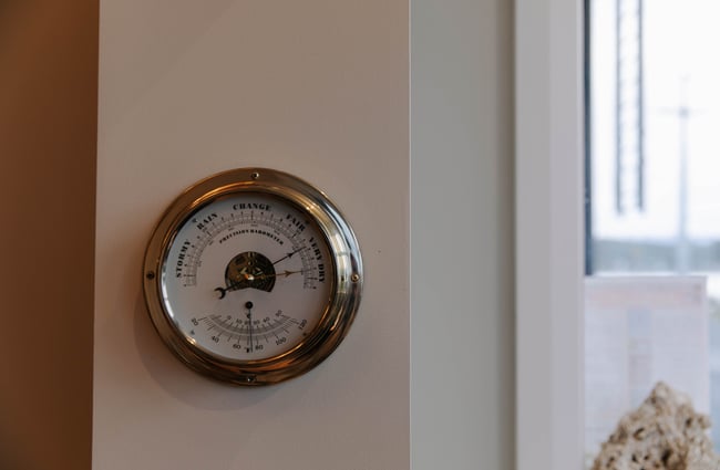 Weather barometer hanging on the wall at The Pier Hotel.