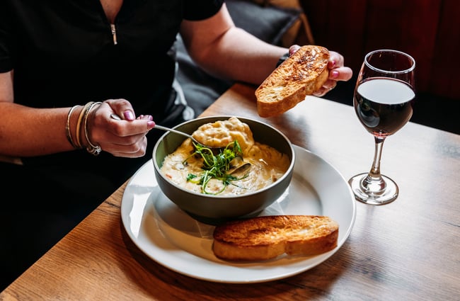 Soup and a glass of wine on the table at The Post Office Cafe and Bar.