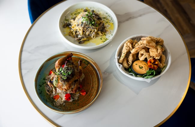 Three meals on a white table inside The Rabbit in Ashburton.