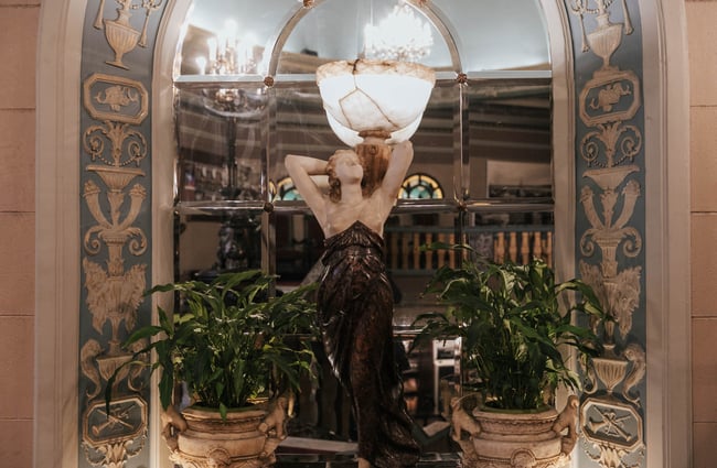 A stone sculpture in front of a mirror.