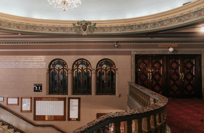 Upstairs in the foyer, looking across to stained glass windows.