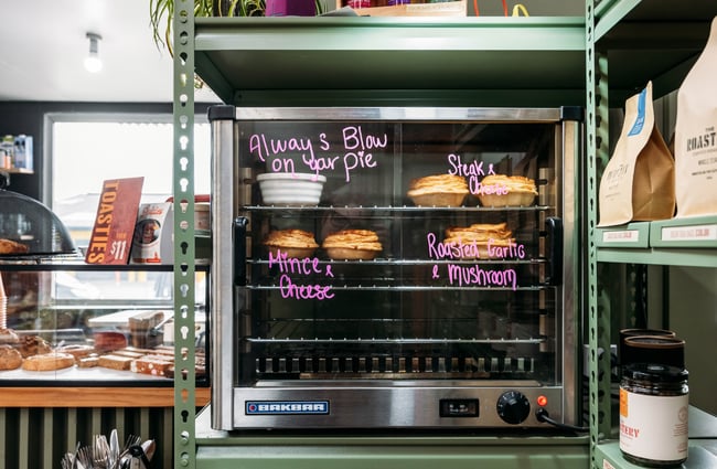 Pies in a pie warmer at The Roastery.