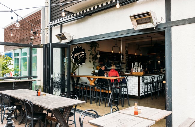 An outdoor dining area at The Salt and Wood Collective in Kapiti.