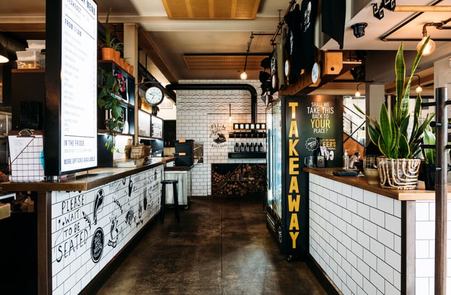 The takeaway pick up area inside a large bar.