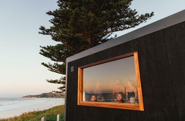People in a sauna looking out a window.
