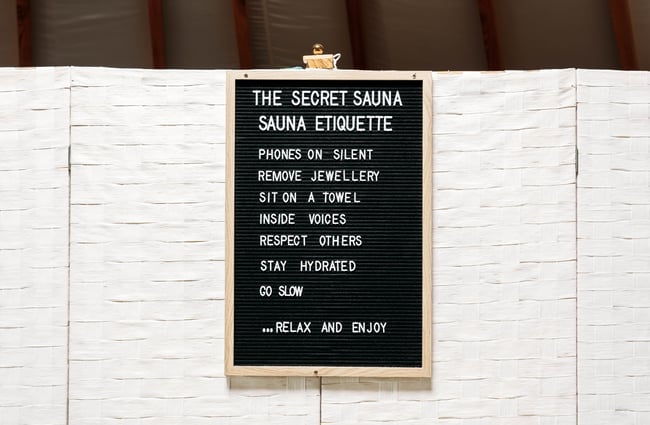 Secret Sauna etiquette board in the lounge yurt.