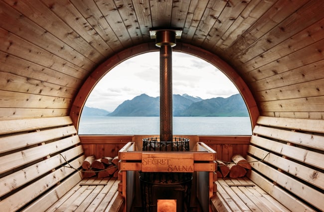 Interior of the sauna at Secret Sauna with a view of the lake through the window.