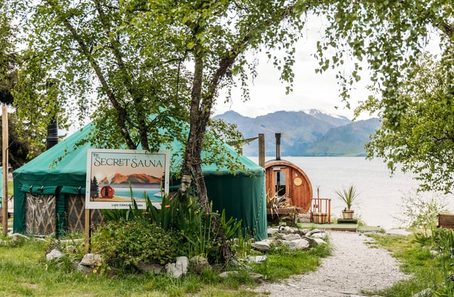 The Secret Sauna yurt and wooden sauna beside the lake.