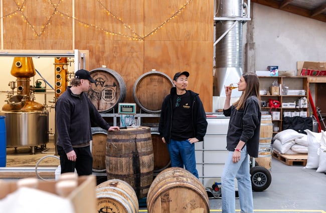 Group of people doing a tasting in the distillery at The Spirits Workshop.