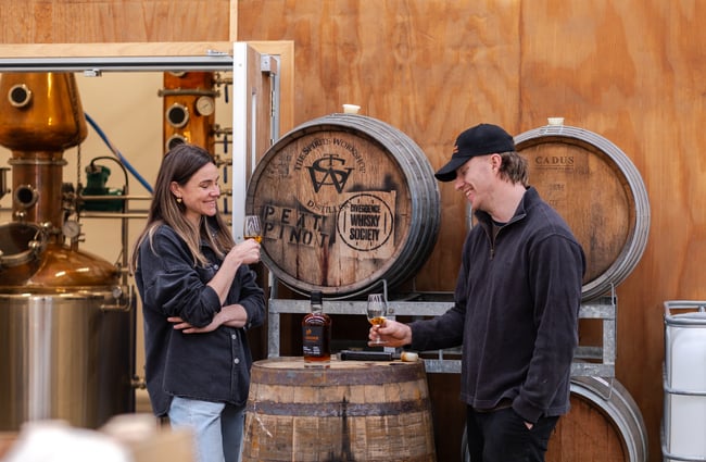 Two people tasting whiskey in the distillery at The Spirits Workshop.