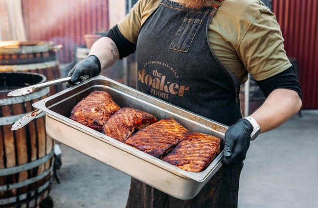 Meat in a tray being carried.