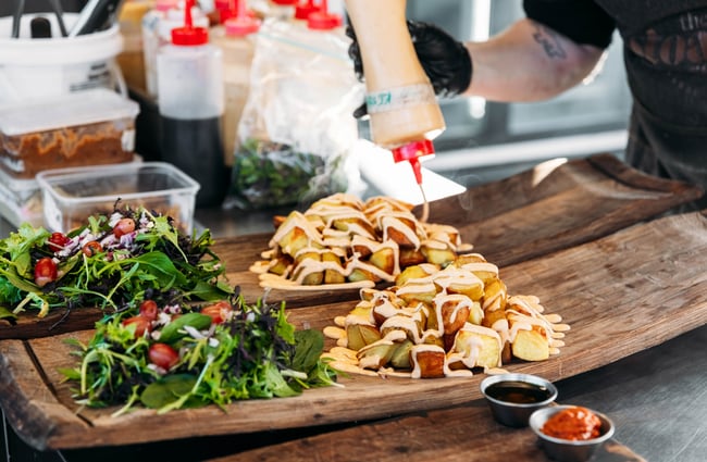 Sauce being poured onto chips.