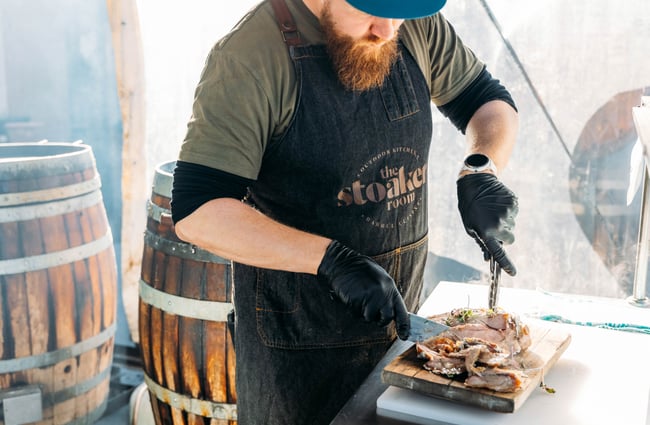 A man cutting up meat.