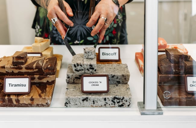 A close up of fudge in a glass cabinet.