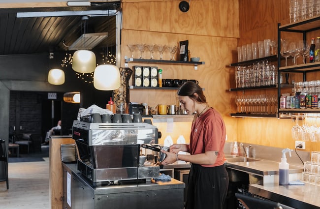 A barista making coffee.