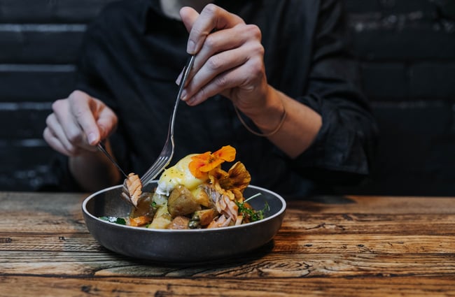 A customer eating a plate of food.