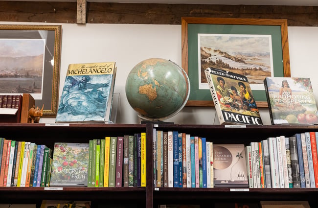 Globes and books on a shelf at the bookshop in The Tannery.
