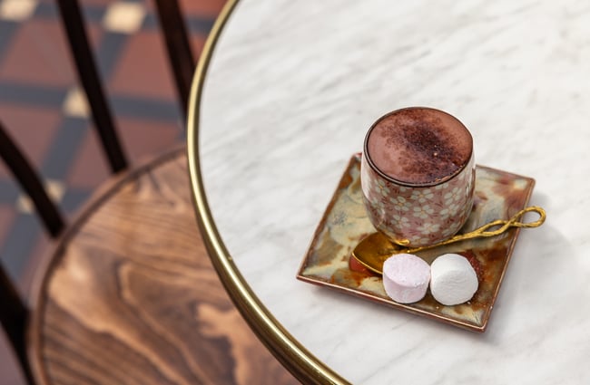 A hot chocolate sitting on the table at The Tannery.