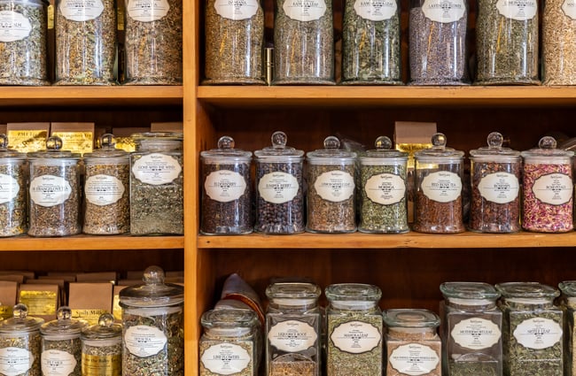Jars of herbs lined up on a shelf at a shop in The Tannery.