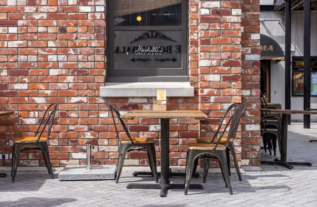 Table and chairs on the footpath outside a cafe at The Tannery.