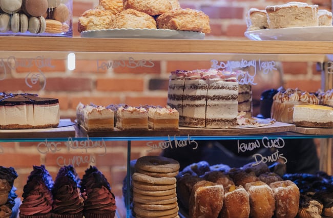 Close up of sweet food inside the glass cabinet.