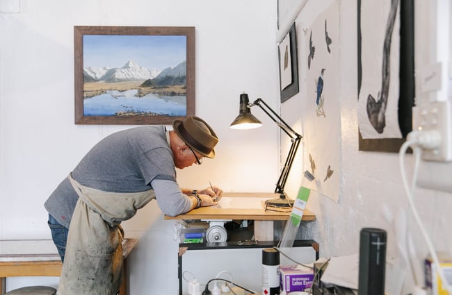 Artist drawing under a lamp at The Terraces in Ōamaru.