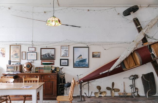 Old artifacts on a dresser and land yacht at The Terraces with table in foreground in Ōamaru.