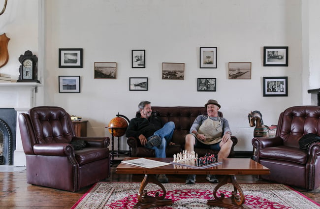 Owners of The Terraces sitting on chesterfield couch in Ōamaru.
