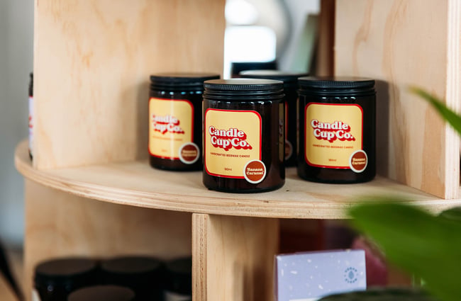 Close up of Candle Cup Co products on light wooden shelf