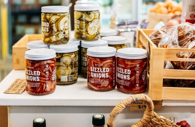 A close up of jars of pickled onions.