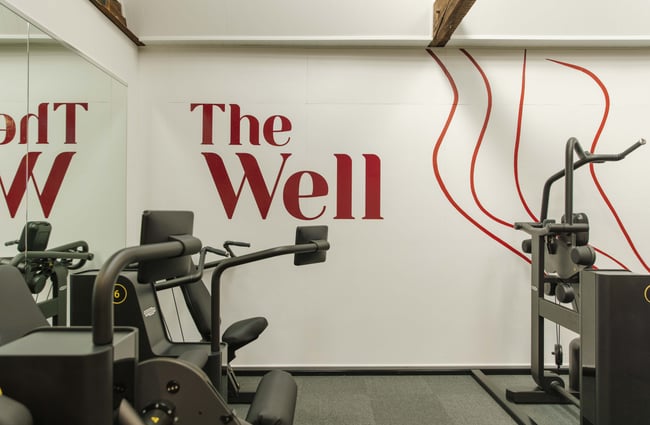 The Well signage behind a machine at The Well - Whole Body Studios.