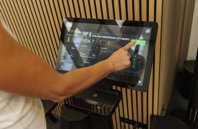 Client using a machine at The Well - Whole Body Studios.