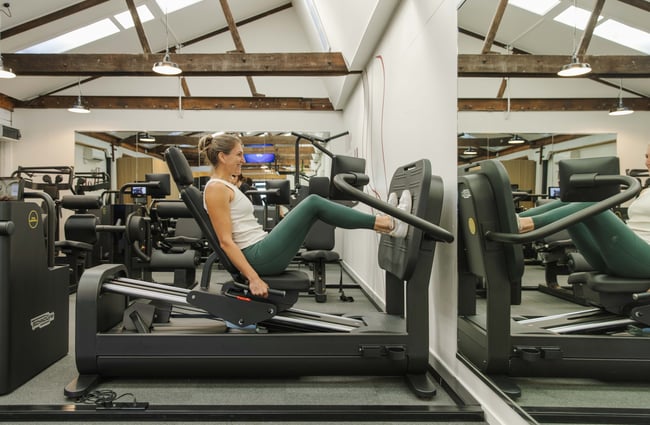 Gym user on a machine at The Well - Whole Body Studios.