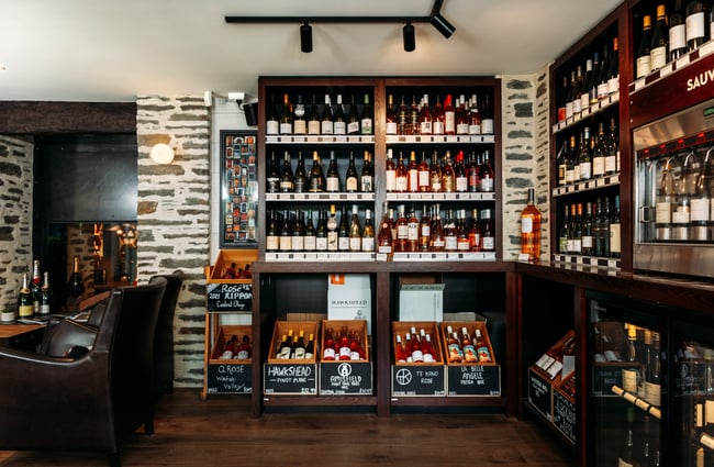 Bottles of wine on display on shelves.
